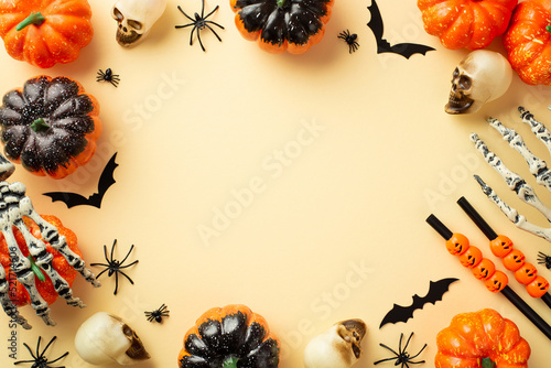 Halloween decorations concept. Top view photo of pumpkins skulls skeleton hands straws spiders and bats silhouettes on isolated beige background with copyspace in the middle