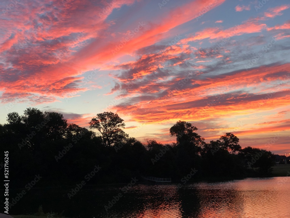 Gorgeous streaks of sunrise clouds in the skies reflected in the lake Gorgeous streaks of sunrise clouds in the skies reflected in the lake