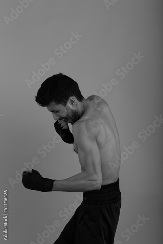 Kickboxer at training in black and white