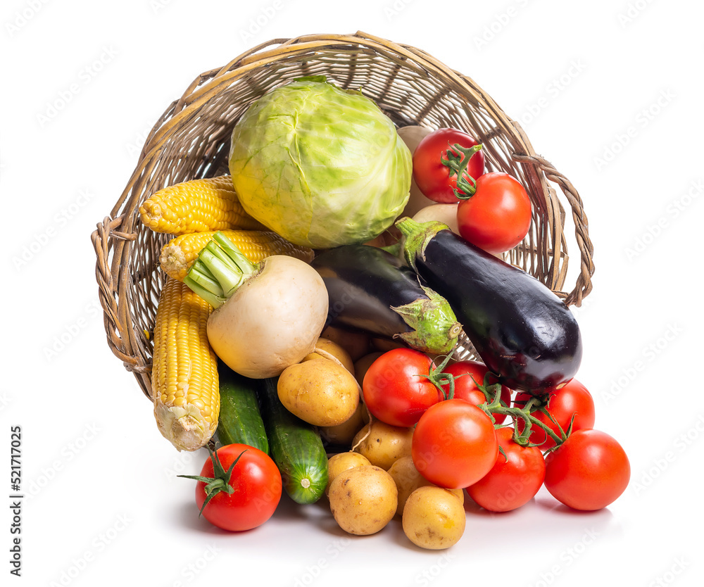 Overturned basket with vegetables on a white background. Isolate