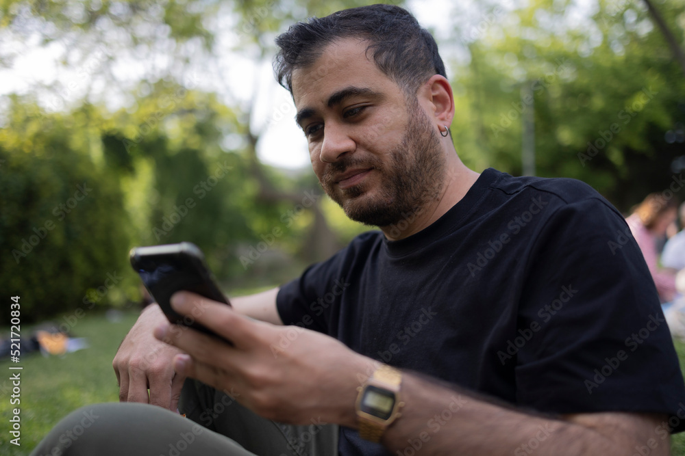 Using mobile phone at open air. Texting, socializing on internet and social media concept photo. Using mobile phone at open air. Texting, socializing on internet and social media concept photo.