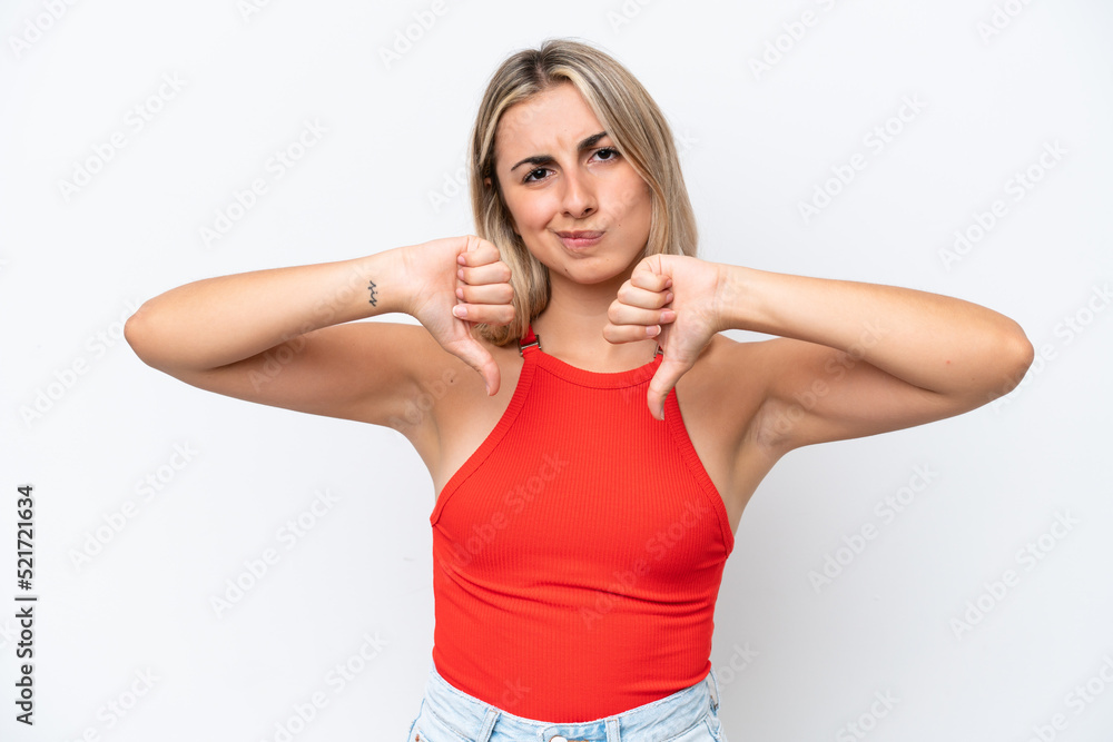 Young caucasian woman isolated on white background showing thumb down with two hands Young caucasian woman isolated on white background showing thumb down with two hands