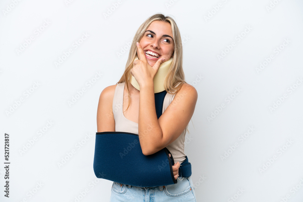 Woman with broken arm and wearing a sling isolated on white background happy and smiling Woman with broken arm and wearing a sling isolated on white background happy and smiling