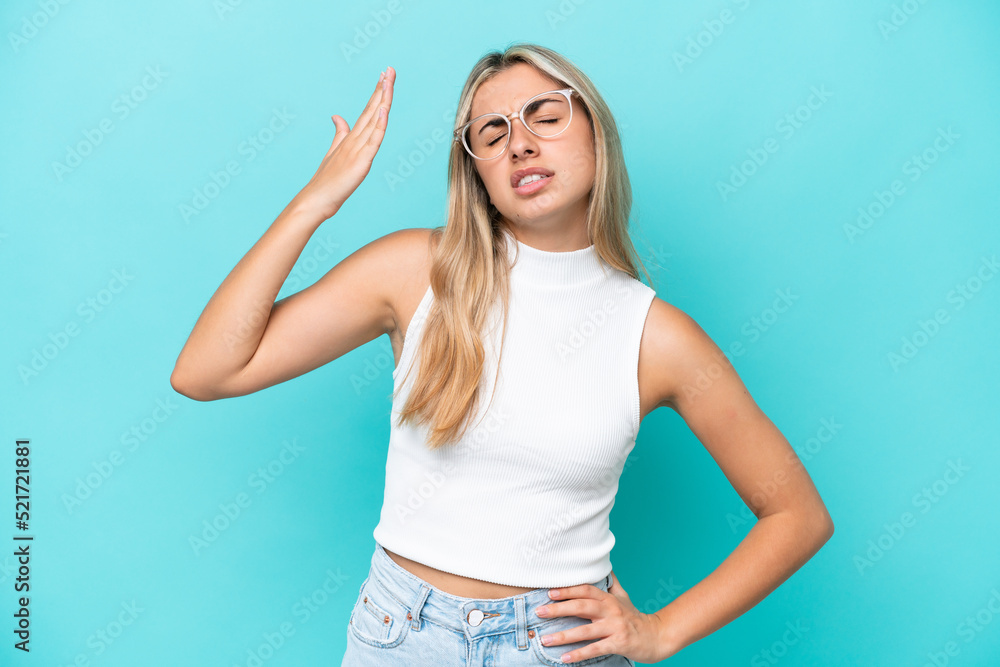 Fototapeta premium Young caucasian woman isolated on blue background with tired and sick expression