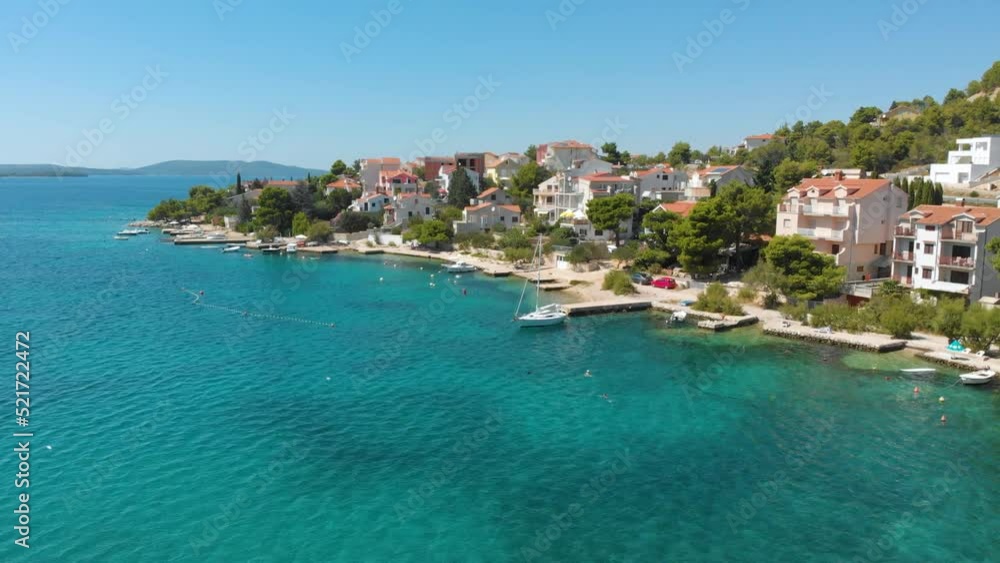 Croatia. Coast of the Adriatic Sea. Small town by the sea. Summer. Tourist season. Popular place to relaxation. Drone. Aerial view. The camera moves forward