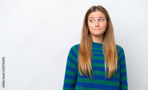 Young caucasian woman isolated on white background making doubts gesture looking side © luismolinero