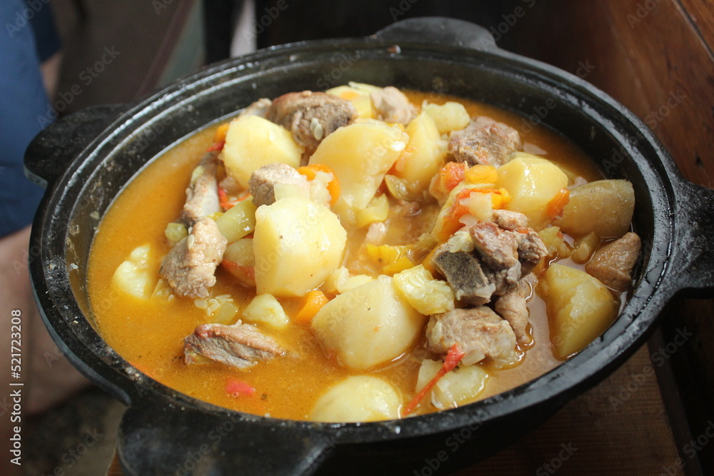 stewed potatoes with vegetables and shurpa meat in a close-up cauldron. Homemade food. Food in nature. delicious national dish stewed potatoes with vegetables and shurpa meat in a close-up cauldron. Homemade food. Food in nature. delicious national dish