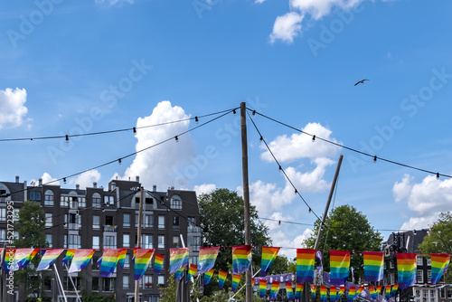 Photography Celebration of pride month in Amsterdam: Rainbow flag hanging outside a building along a street, Symbol of LGBT community in Dutch Social movements