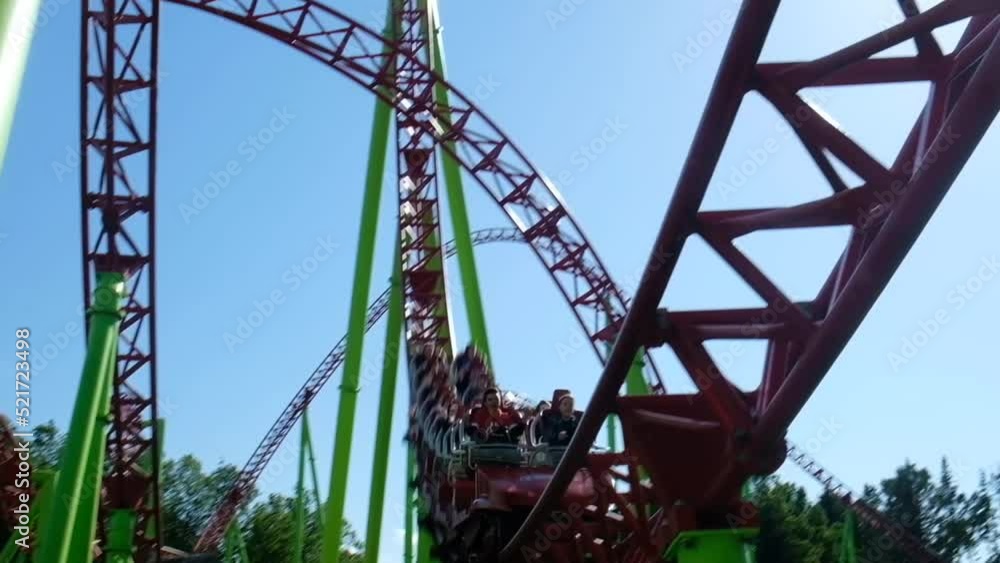 Roller coaster in the amusement park. Cheerful entertainments in park of attractions Roller coaster in the amusement park. Cheerful entertainments in park of attractions