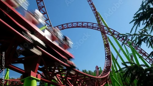 Roller coaster in the amusement park. Cheerful entertainments in park of attractions photo