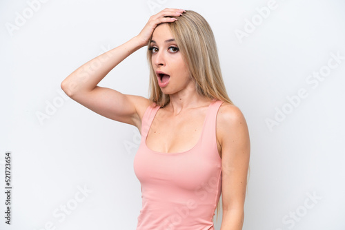 Pretty blonde woman isolated on white background doing surprise gesture while looking to the side