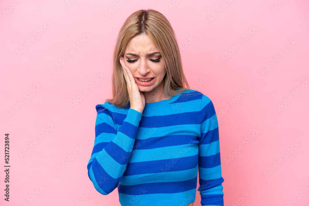 Pretty blonde woman isolated on pink background with toothache Pretty blonde woman isolated on pink background with toothache