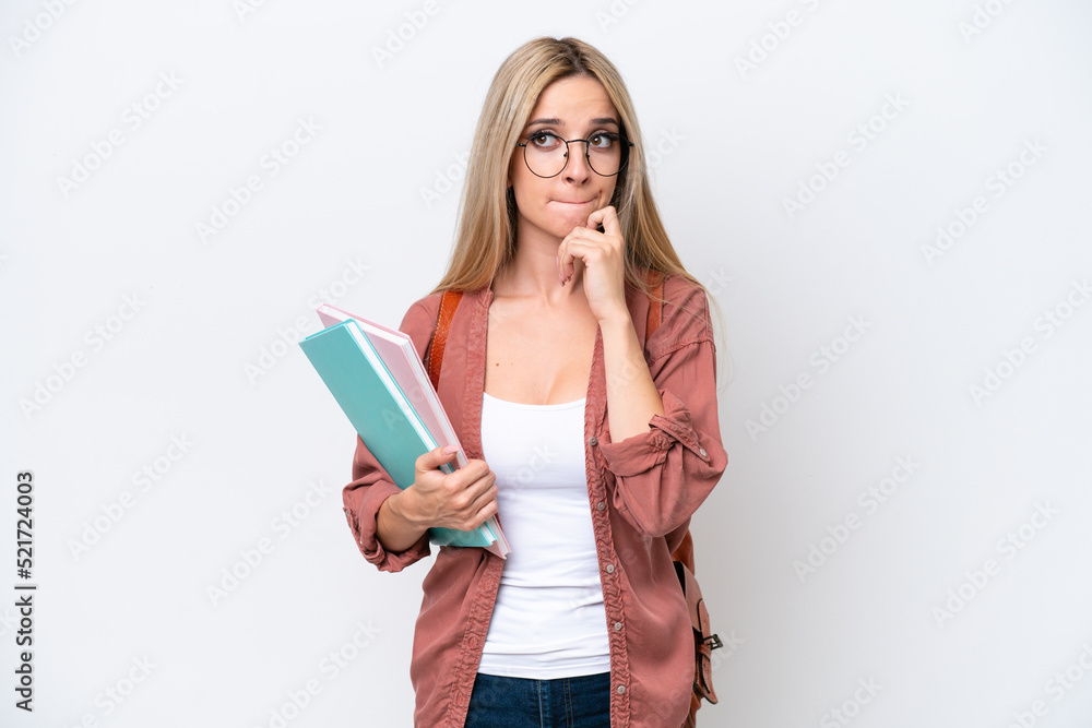 Pretty student blonde woman isolated on white background having doubts and thinking Pretty student blonde woman isolated on white background having doubts and thinking