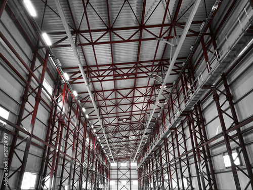 Truss ceiling and metal pillars and girders. Support constructions. Industrial building metal framework. Low angle view © Philipp Berezhnoy