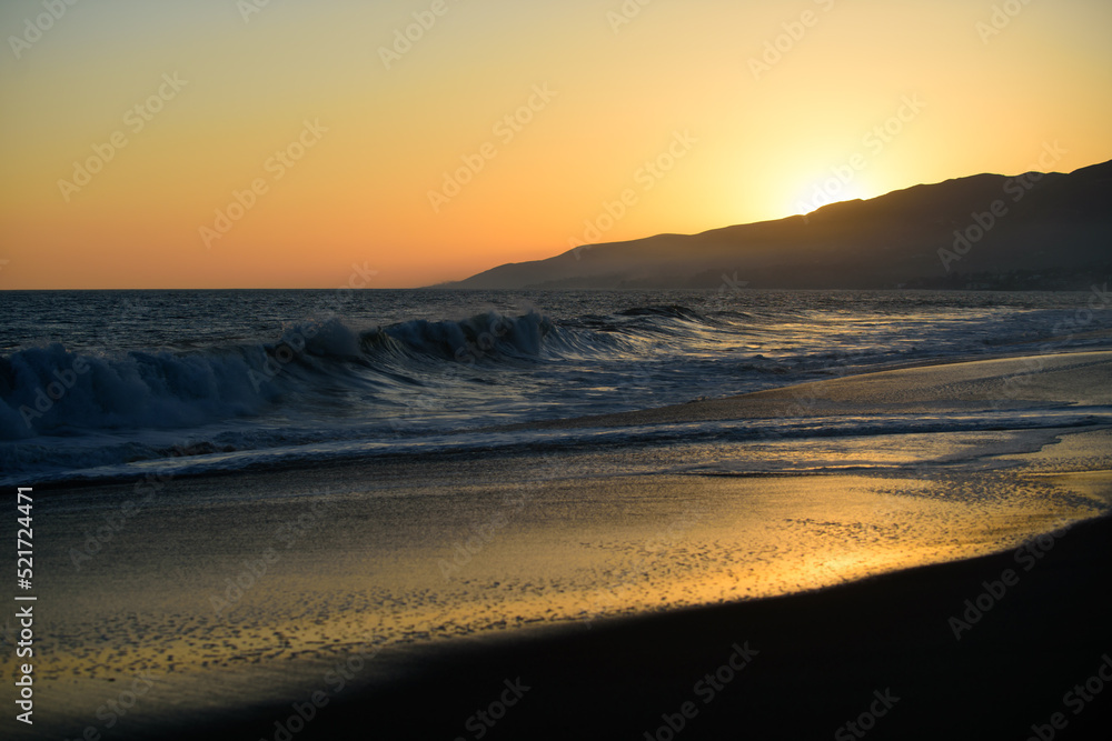 Sunset over sea with golden dramatic sky panorama. Calm sea with sunset sky. Ocean and sky background. Summer and blue sky with blue sea waves soft surface and beauty sunset.