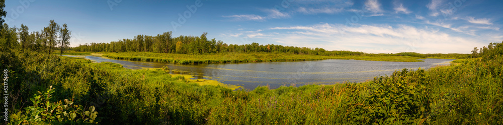 Tranquil nature landscape of trail and lake in Elk Nation Island Park near Edmonton in the Province of Alberta, Canada