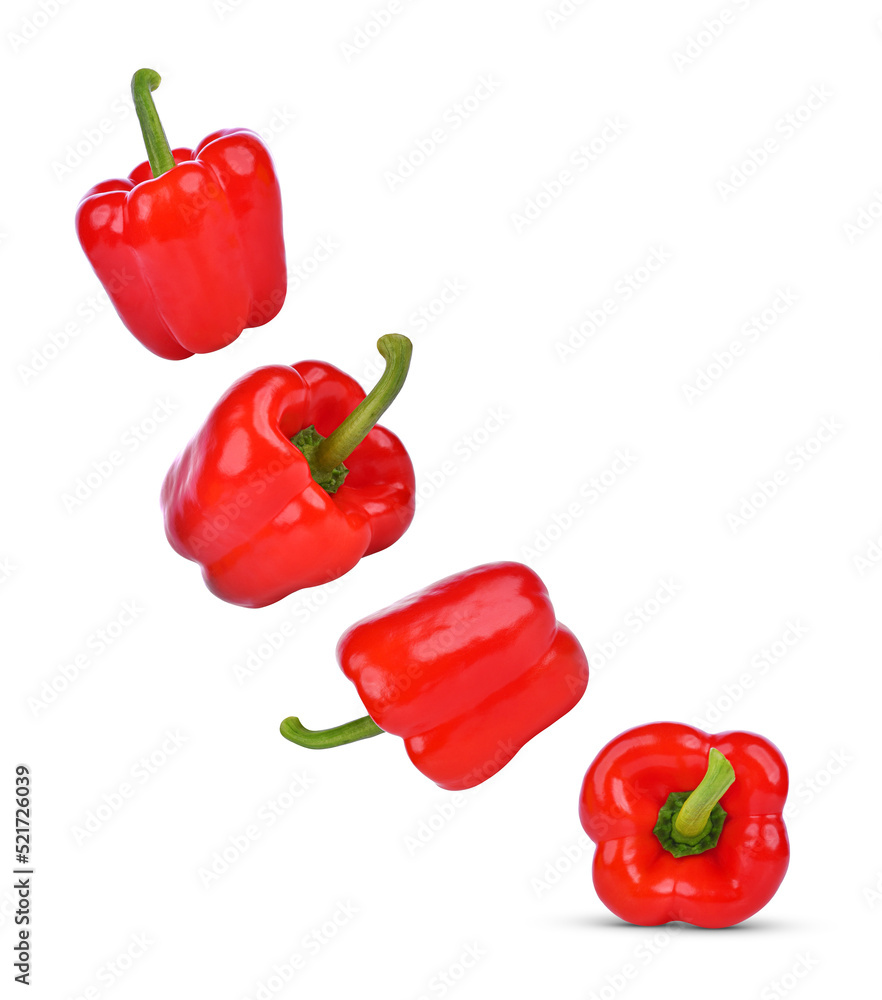 Red bell peppers falling in the air isolated on white background. Red bell peppers falling in the air isolated on white background.