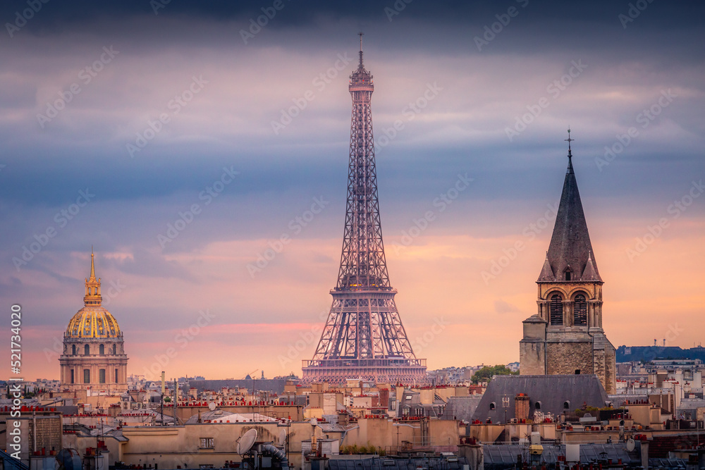 Eiffel tower and parisian roofs at sunrise Paris, France