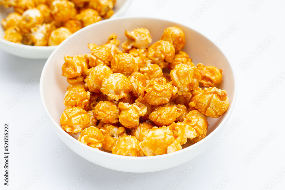 Honey caramel popcorn on white background. Honey caramel popcorn on white background.