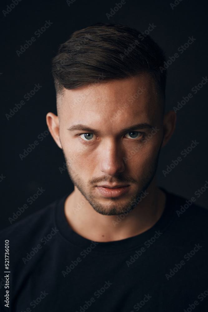 Modelling snapshots. Evil self-confident tanned attractive handsome man in classic suit jacket looks at camera posing isolated in black studio background. Fashion offer. Copy space for ad. Closeup Modelling snapshots. Evil self-confident tanned attractive handsome man in classic suit jacket looks at camera posing isolated in black studio background. Fashion offer. Copy space for ad. Closeup