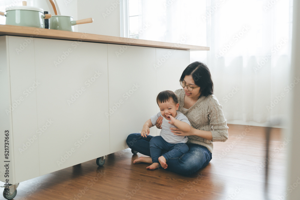 Happy smiling Asian mother and little son having fun time at home Happy smiling Asian mother and little son having fun time at home
