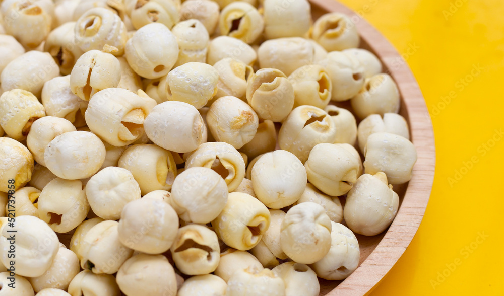Dried lotus seeds on yellow background. Dried lotus seeds on yellow background.