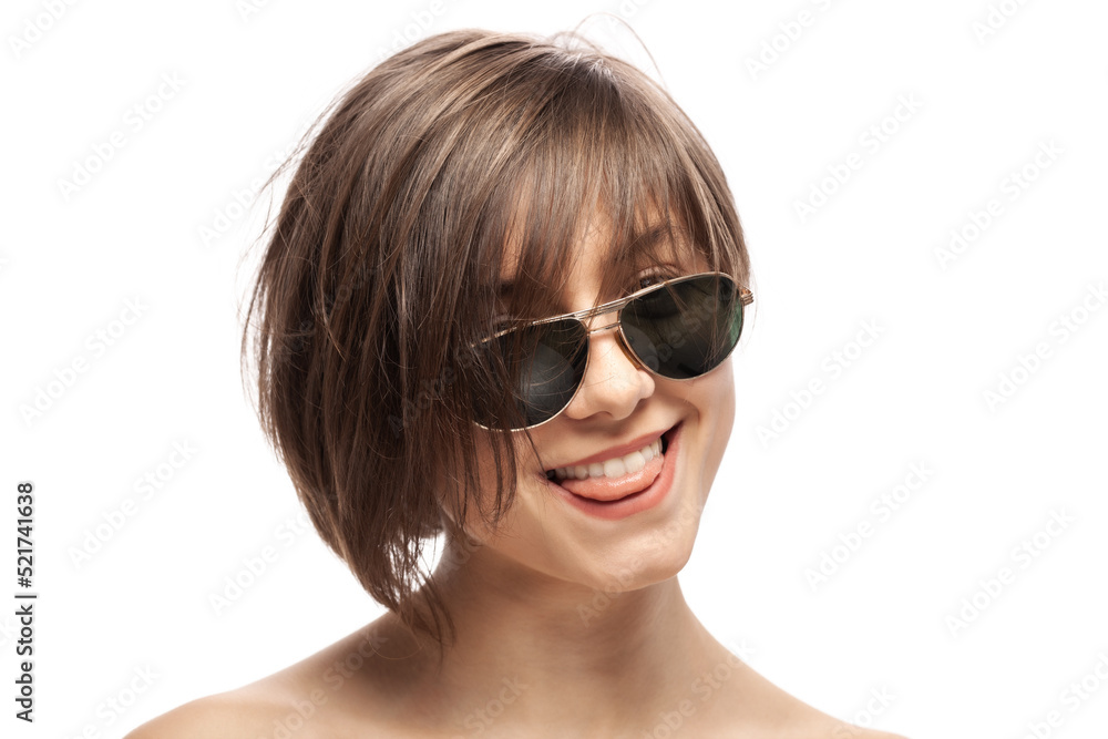 Beautiful girl fashion portrait wearing sunglasses. Happy face expression with tongue out. Isolated against white background. . Beautiful girl fashion portrait wearing sunglasses. Happy face expression with tongue out. Isolated against white background. .