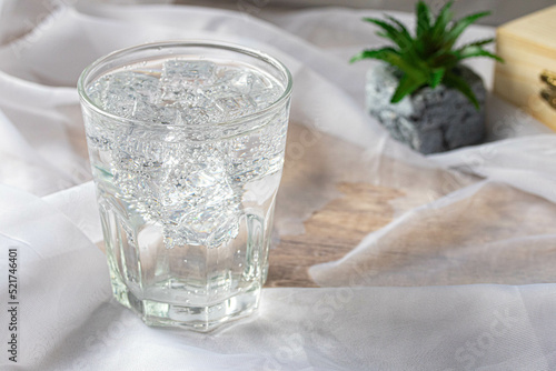 Soda water with ice in a clear glass. Copy space.