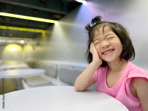 Beautiful girl laugh with big smile on the table with copy space in background