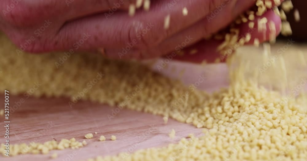 Move your hands cereal porridge couscous from wheat or millet, cooking dishes from traditional cereals crushed yellow couscous Move your hands cereal porridge couscous from wheat or millet, cooking dishes from traditional cereals crushed yellow couscous