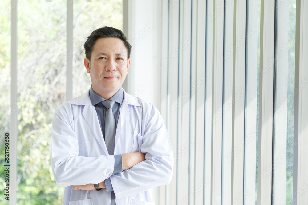 Portrait of asian senior doctor standing and cross arms posing in lobby hospital. Portrait of asian senior doctor standing and cross arms posing in lobby hospital.