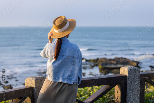 Woman look at the sea under sunset