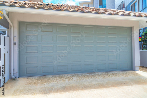 Garage exterior with light gray sectional door at La Jolla in San Diego, California
