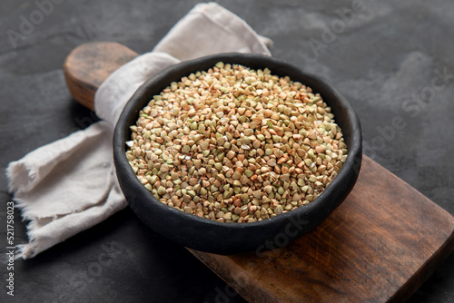 Raw green buckwheat on dark background. Food ingredients.