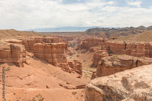 A view from the top of charyn canyon looking across the red canyon walls.