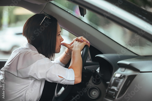 young beautiful woman driver driving her car is upset and worried, has anxiety and negative feelings