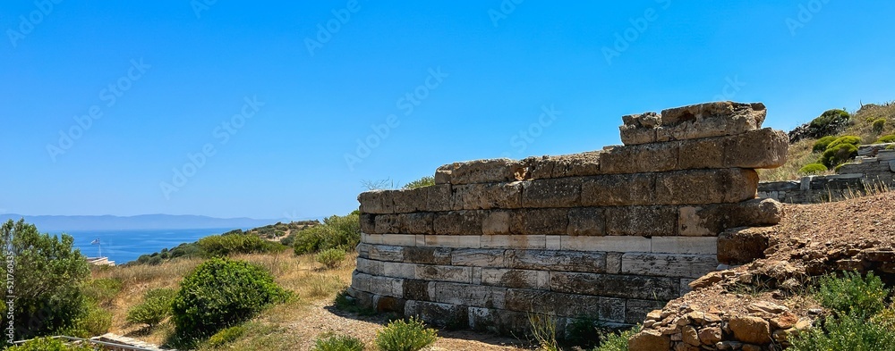 Remains of an ancient stone block wall near the sea in Greece.