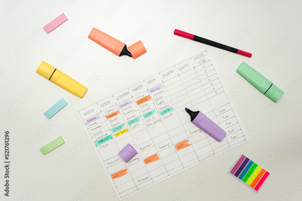 School schedule. A sheet with a handwritten school schedule lies on a white table strewn with colorful markers and stickers. School Time Management School schedule. A sheet with a handwritten school schedule lies on a white table strewn with colorful markers and stickers. School Time Management