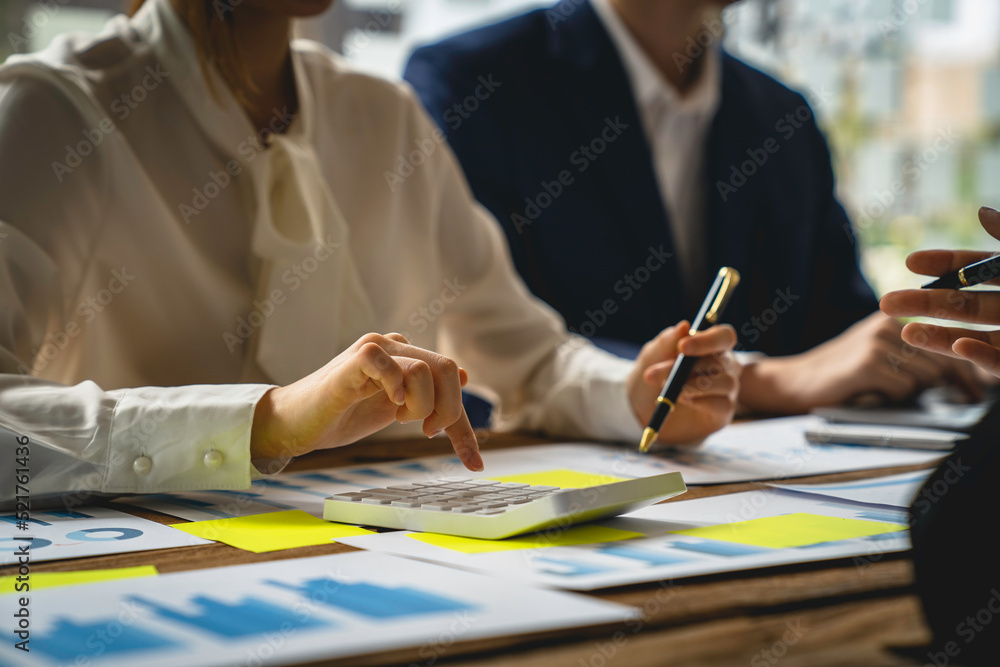 Financial teamwork with Marketing and Accounting Business professionals working together at office desk, hands close up pointing out financial data on a report negotiation, Analysis, Discussion Financial teamwork with Marketing and Accounting Business professionals working together at office desk, hands close up pointing out financial data on a report negotiation, Analysis, Discussion