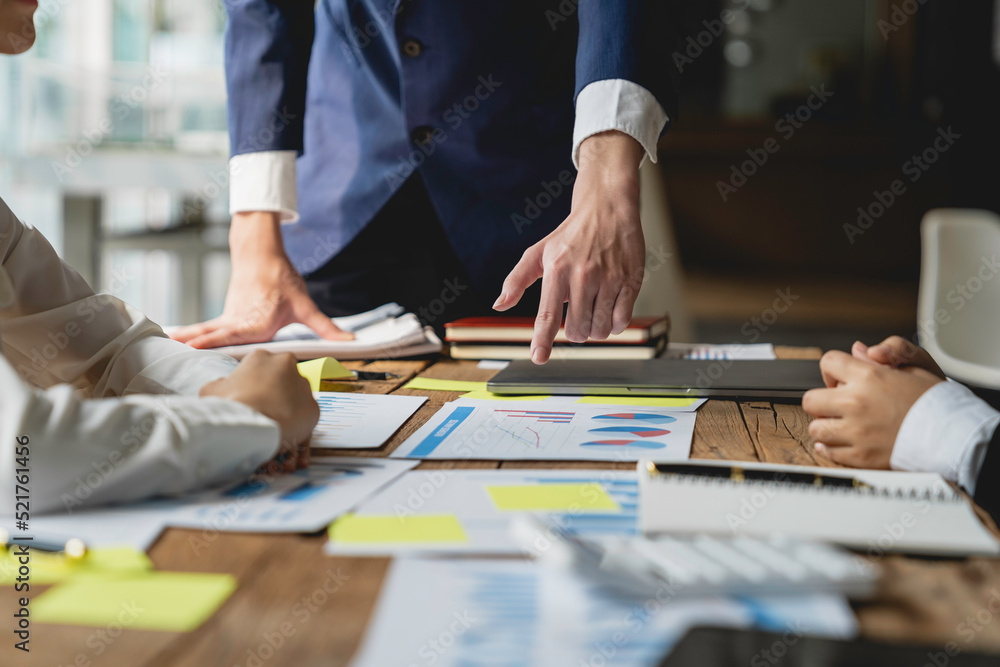 Financial teamwork with Marketing and Accounting Business professionals working together at office desk, hands close up pointing out financial data on a report negotiation, Analysis, Discussion