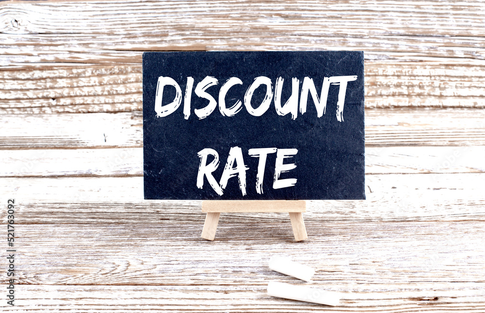 DISCOUNT RATE text on the Miniature chalkboard on wooden background