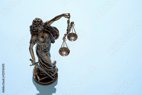 Фотография Themis statue is a symbol of the tribunal of freedom of the verdict of crime with balance scales on a blue pastel bright background and save space