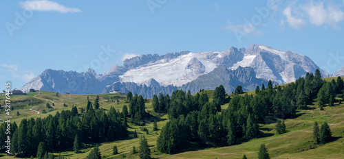 Amazing landscape to the Marmolada and its glaciers during summer time. Melting of glaciers due to global warming. It is the highest mountain of the Dolomites. Italian alps. Summer 2022 photo