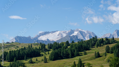 Amazing landscape to the Marmolada and its glaciers during summer time. Melting of glaciers due to global warming. It is the highest mountain of the Dolomites. Italian alps. Summer 2022