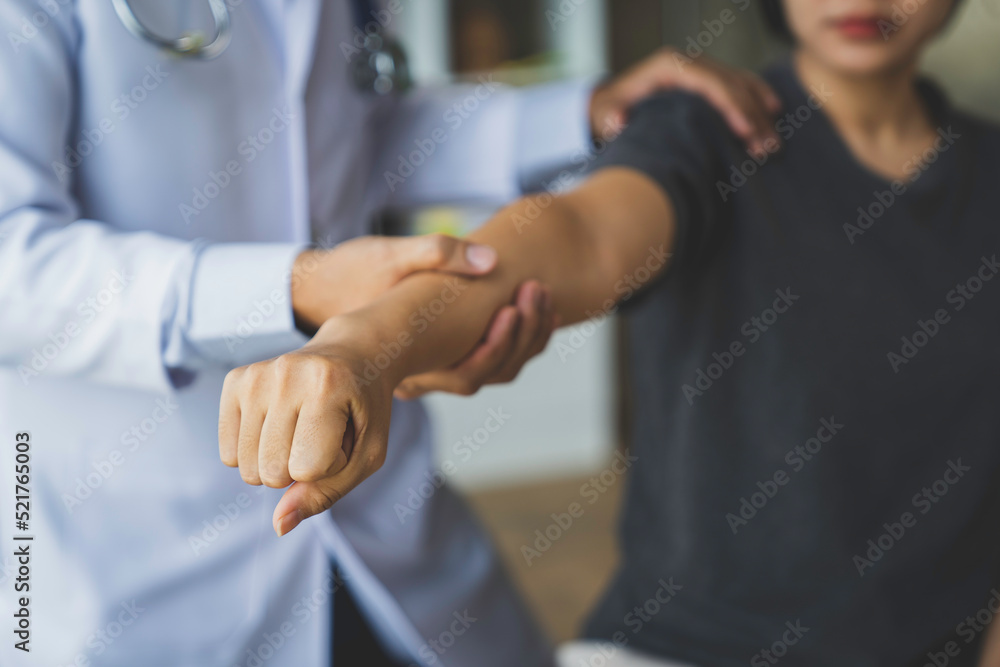 The doctor counsels the patient about pain in the muscles of the arms and elbows. office syndrome problem physical therapy diagnostic concept The doctor counsels the patient about pain in the muscles of the arms and elbows. office syndrome problem physical therapy diagnostic concept