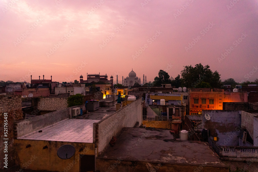 Taj Mahal at sunset with the city of Agra in the background.