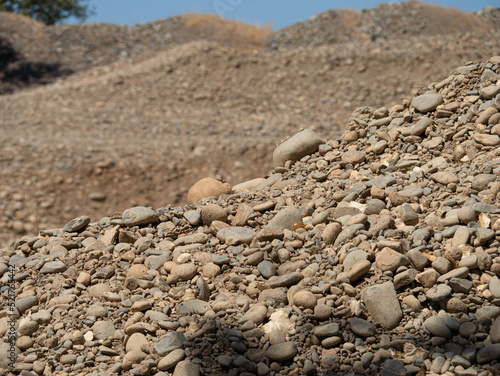 Piles of river rocks from gold mining dredge 