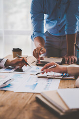 Financial analyst analyzes business finance reports on laptop and graph documents during corporate meeting discussions showing successful teamwork, business meeting ideas, marketing.