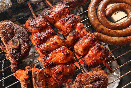South African braai, boerewors sausage, lamb chops, and chicken kebabs meat on the grill