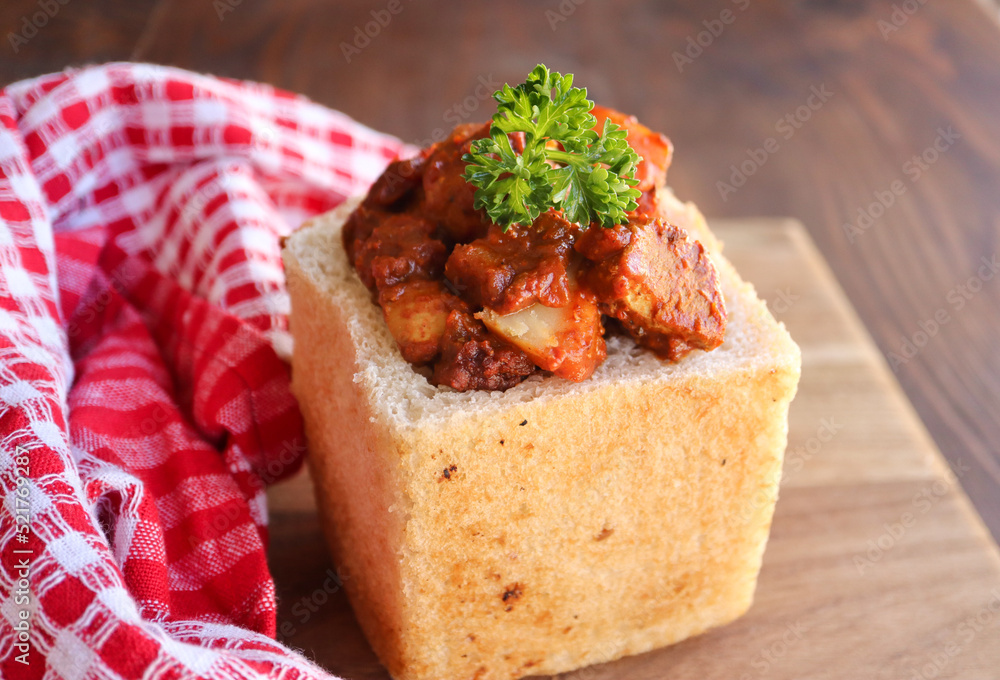 South African cuisine. Bunny chow. Loaf of bread filled with chicken